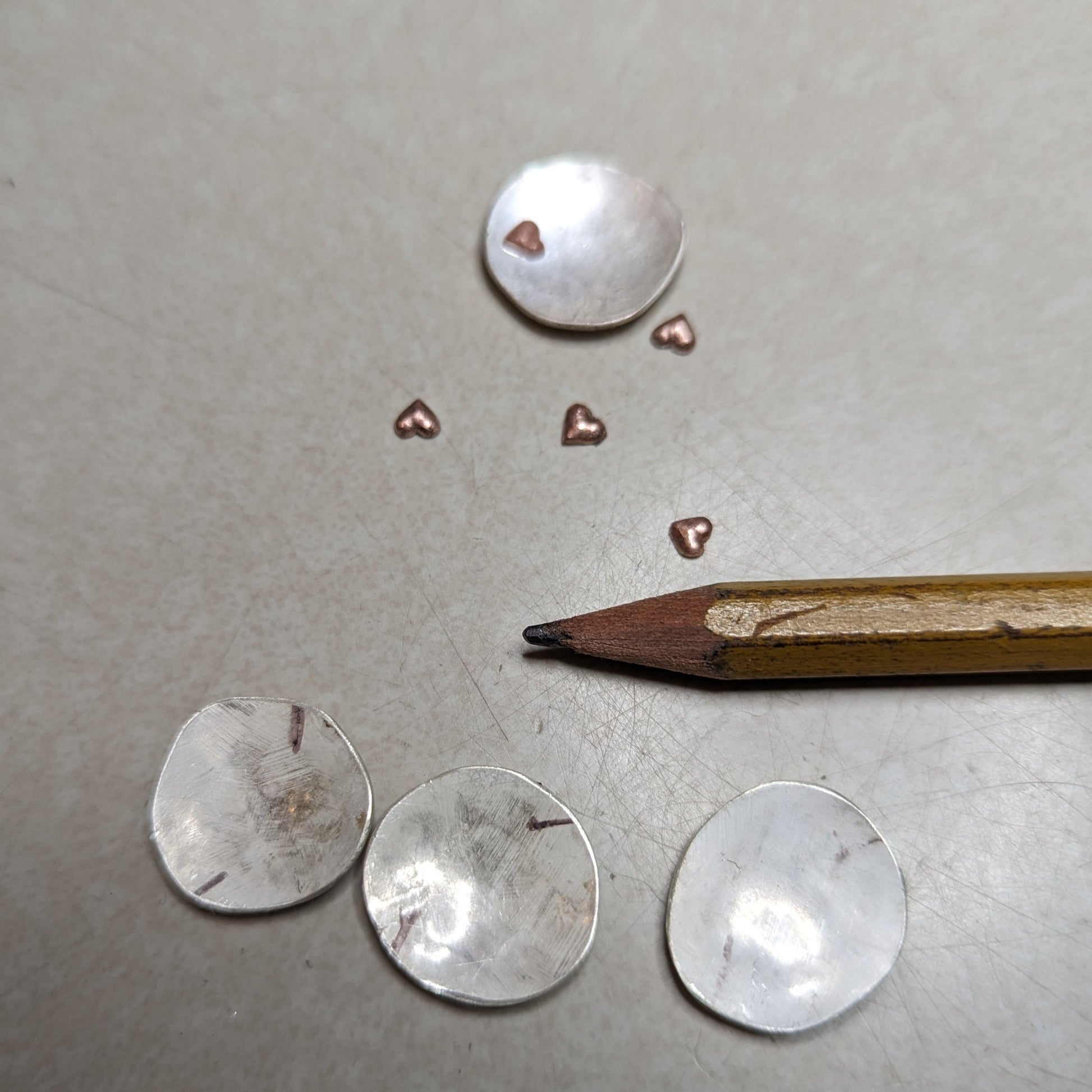 recycled silver discs with copper hearts